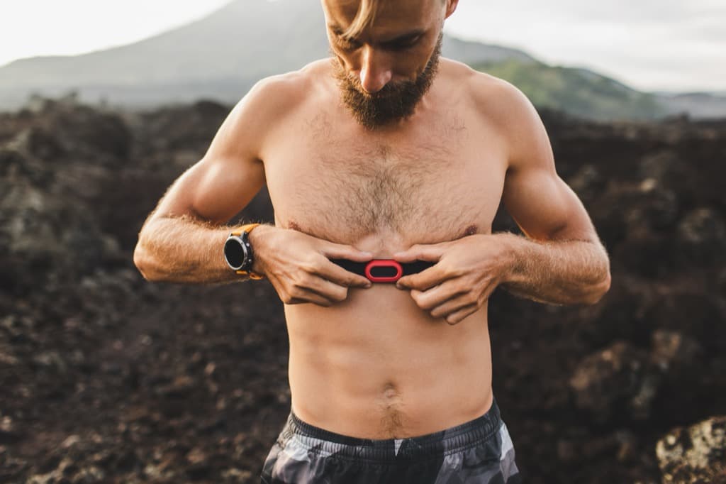 Runner wearing a chest heart rate monitor and GPS watch
